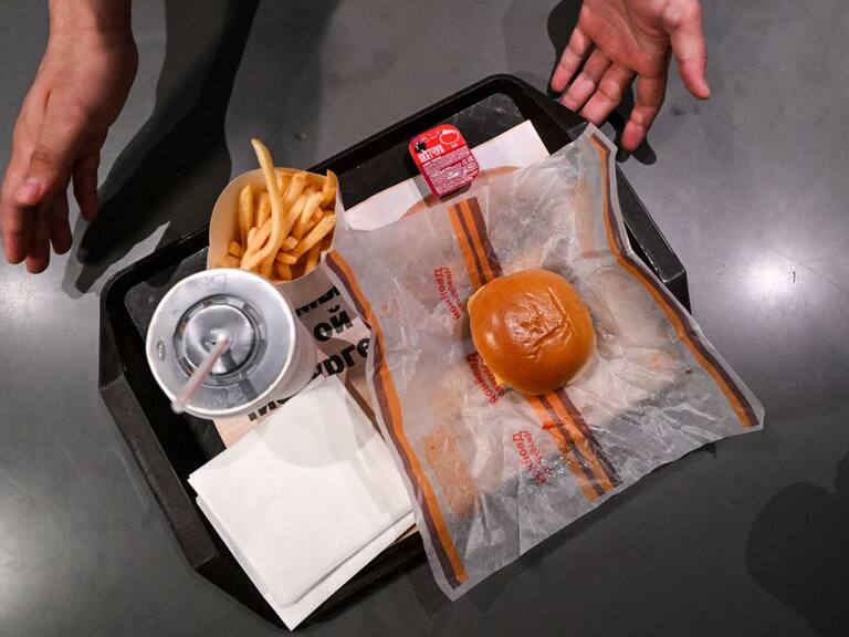 This photograph taken on on June 12, 2022 shows a double cheeseburger menu' including fries, sauce and a soft drink in the Russian version of a former McDonald's restaurant during the opening ceremony in Moscow . - Former McDonald's restaurants in Russia have been renamed "Vkusno i tochka" ("Delicious. Full Stop"), the new owner said ahead of their grand re-opening . (Photo by Kirill KUDRYAVTSEV / AFP) (Photo by KIRILL KUDRYAVTSEV/AFP via Getty Images)