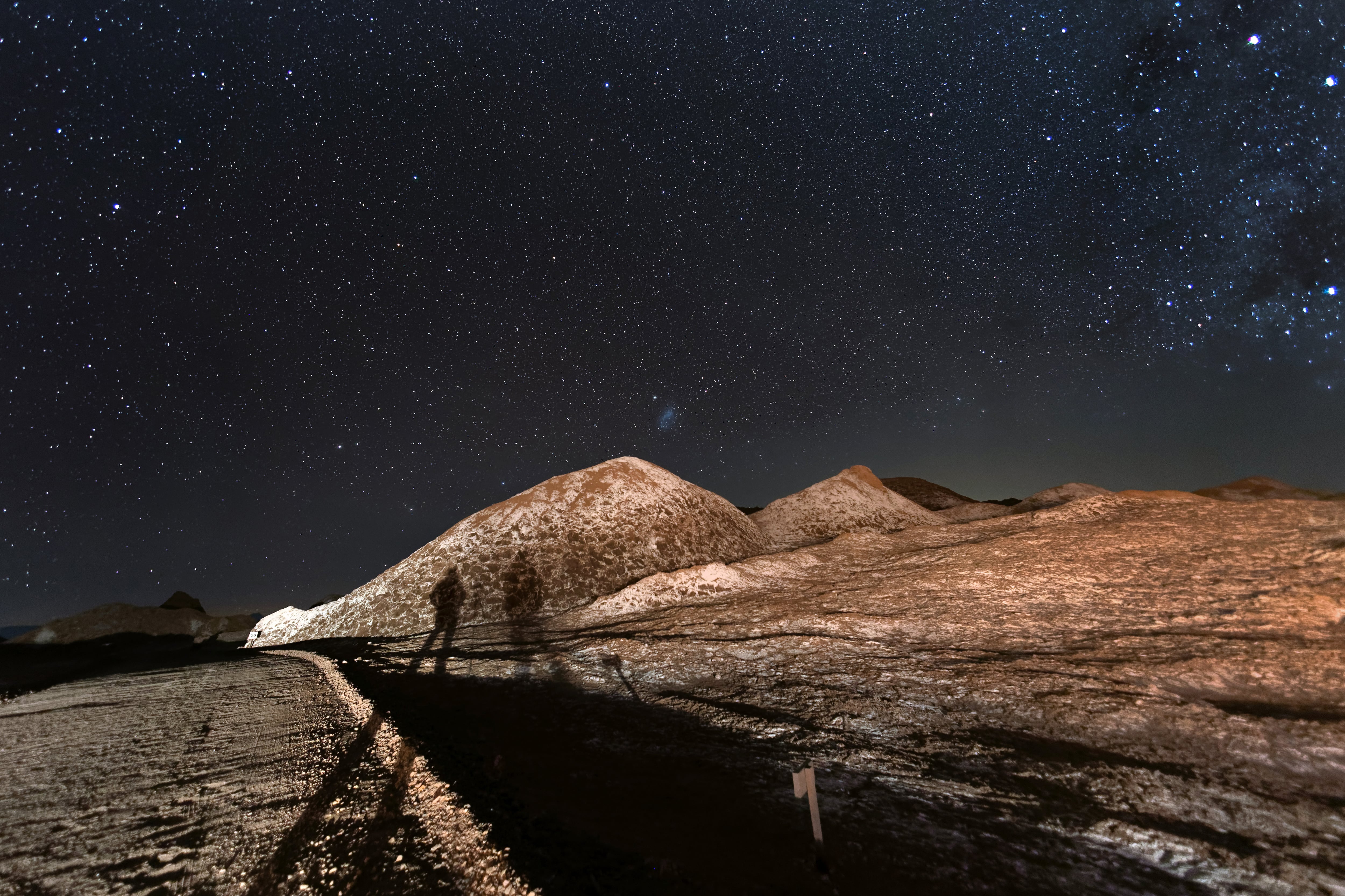 SAN PEDRO DE ATACAMA, CHILE - AUGUST 26: The Milky Way appears over salt formations in the Valle de la Luna in the Atacama Desert, considered the driest place on earth on August 26, 2022 near San Pedro de Atacama, Chile. The extreme aridity makes the Atacama Desert one of the clearest places on earth to view the night sky. Much of the region receives less than half an inch of rainfall per year, and some areas none at all for hundreds of years. Located in Chile's northern third between two mountain ranges, the Atacama is possibly the oldest desert on earth, experiencing extreme aridity for at least 3 million years. The area is home to the Atacama Large Millimeter/submillimeter Array (ALMA) telescope. The Valley of the Moon is so called because of its lunar and even Mars-like appearance. (Photo by John Moore/Getty Images,)