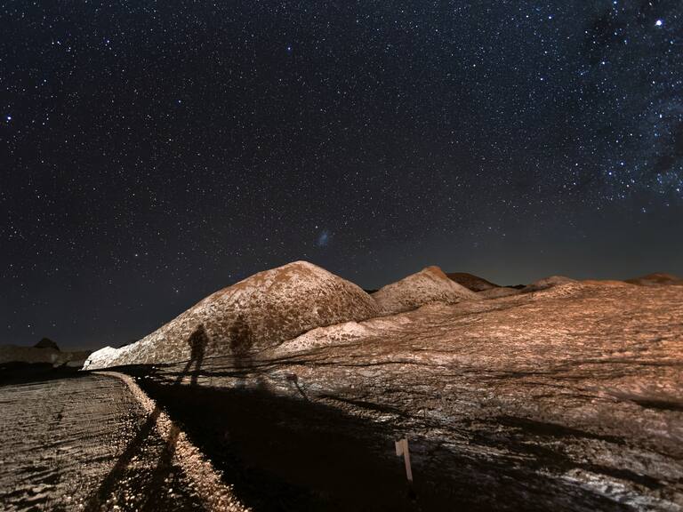 SAN PEDRO DE ATACAMA, CHILE - AUGUST 26: The Milky Way appears over salt formations in the Valle de la Luna in the Atacama Desert, considered the driest place on earth on August 26, 2022 near San Pedro de Atacama, Chile. The extreme aridity makes the Atacama Desert one of the clearest places on earth to view the night sky. Much of the region receives less than half an inch of rainfall per year, and some areas none at all for hundreds of years. Located in Chile's northern third between two mountain ranges, the Atacama is possibly the oldest desert on earth, experiencing extreme aridity for at least 3 million years. The area is home to the Atacama Large Millimeter/submillimeter Array (ALMA) telescope. The Valley of the Moon is so called because of its lunar and even Mars-like appearance. (Photo by John Moore/Getty Images,)