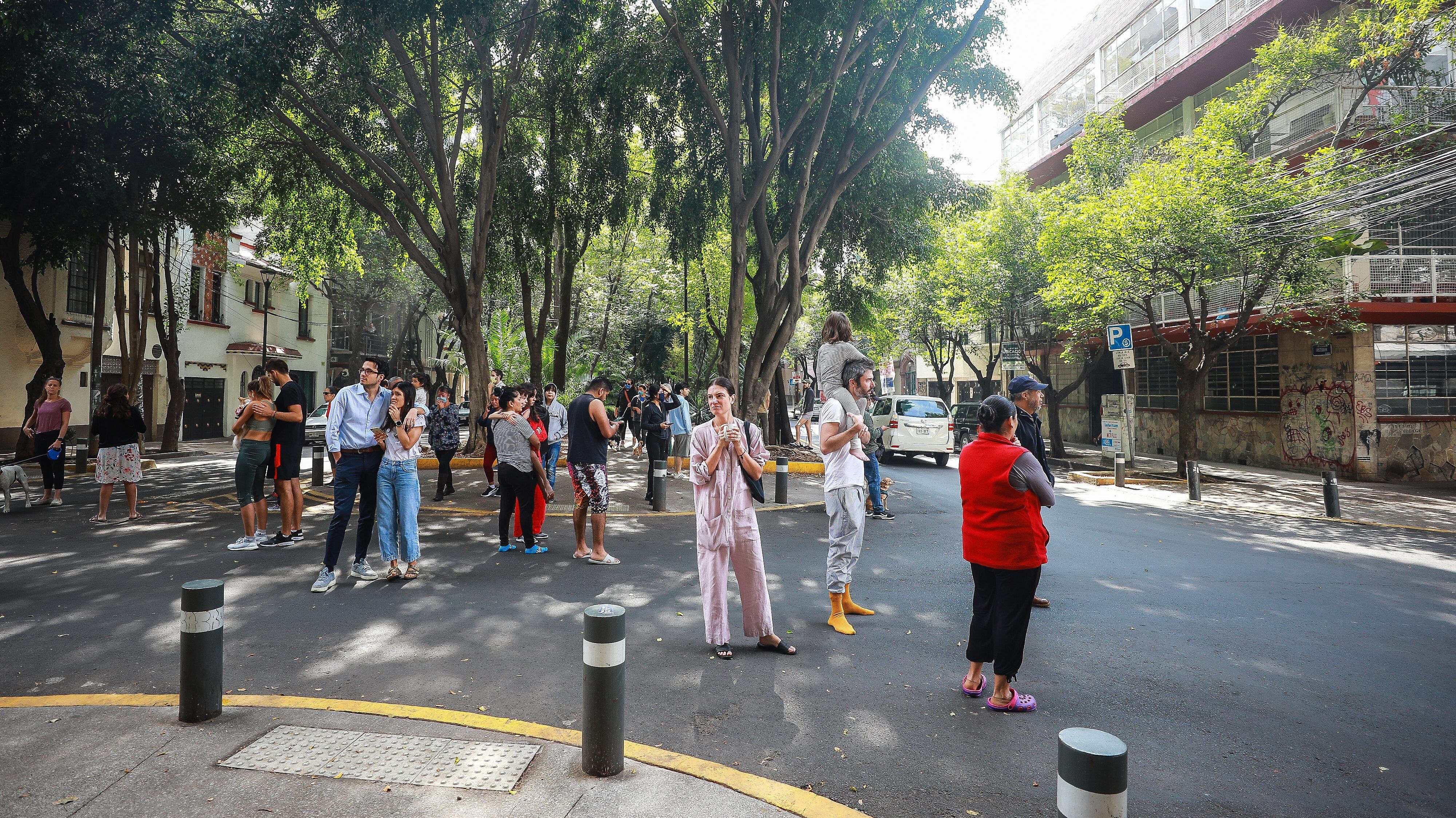 MEXICO CITY, MEXICO - JUNE 23: People stand in the street after evacuating buildings at Condesa neighborhood during an earthquake on June 23, 2020 in Mexico City, Mexico. According to the National Seismological Service a 7.5 magnitude earthquake was registered on Tuesday in Mexico City and in various areas of the country. (Photo by Manuel Velasquez/Getty Images)