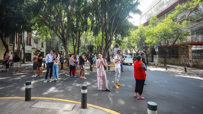 MEXICO CITY, MEXICO - JUNE 23: People stand in the street after evacuating buildings at Condesa neighborhood during an earthquake on June 23, 2020 in Mexico City, Mexico. According to the National Seismological Service a 7.5 magnitude earthquake was registered on Tuesday in Mexico City and in various areas of the country. (Photo by Manuel Velasquez/Getty Images)