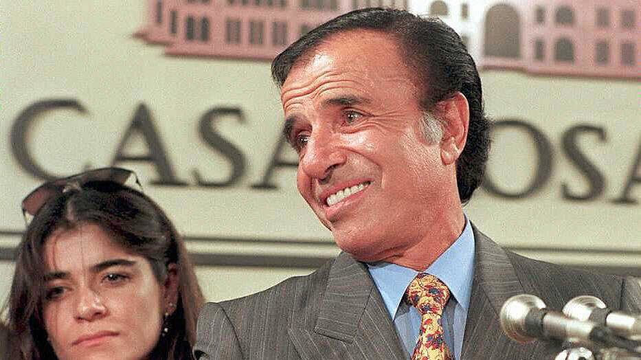 BUENOS AIRES, ARGENTINA: This 14 May 1995 picture shows former Argentinean President Carlos Menem, and his daughter Zulema, in Buenos Aires. Tomorrow, 14 June 2003, Zulemita Menem (32) will marry to Paolo Bertoldi (43), an Italian entrepreneur, in Portofino, Italy. The ceremony though civilian, will also receive religious blessing, and it will be held in the small city of Liguria. AFP PHOTO / DANIEL LUNA (Photo credit should read DANIEL LUNA/AFP via Getty Images)