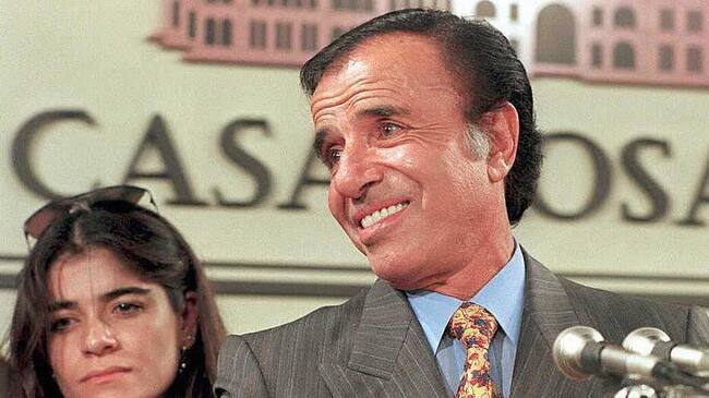 BUENOS AIRES, ARGENTINA: This 14 May 1995 picture shows former Argentinean President Carlos Menem, and his daughter Zulema, in Buenos Aires. Tomorrow, 14 June 2003, Zulemita Menem (32) will marry to Paolo Bertoldi (43), an Italian entrepreneur, in Portofino, Italy. The ceremony though civilian, will also receive religious blessing, and it will be held in the small city of Liguria. AFP PHOTO / DANIEL LUNA (Photo credit should read DANIEL LUNA/AFP via Getty Images)