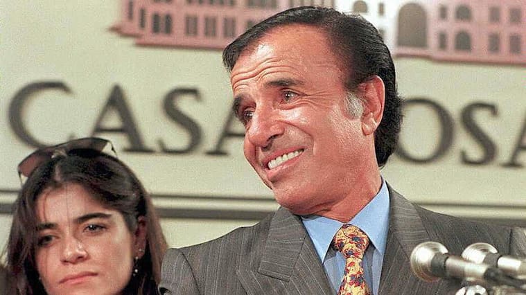 BUENOS AIRES, ARGENTINA: This 14 May 1995 picture shows former Argentinean President Carlos Menem, and his daughter Zulema, in Buenos Aires. Tomorrow, 14 June 2003, Zulemita Menem (32) will marry to Paolo Bertoldi (43), an Italian entrepreneur, in Portofino, Italy. The ceremony though civilian, will also receive religious blessing, and it will be held in the small city of Liguria. AFP PHOTO / DANIEL LUNA (Photo credit should read DANIEL LUNA/AFP via Getty Images)
