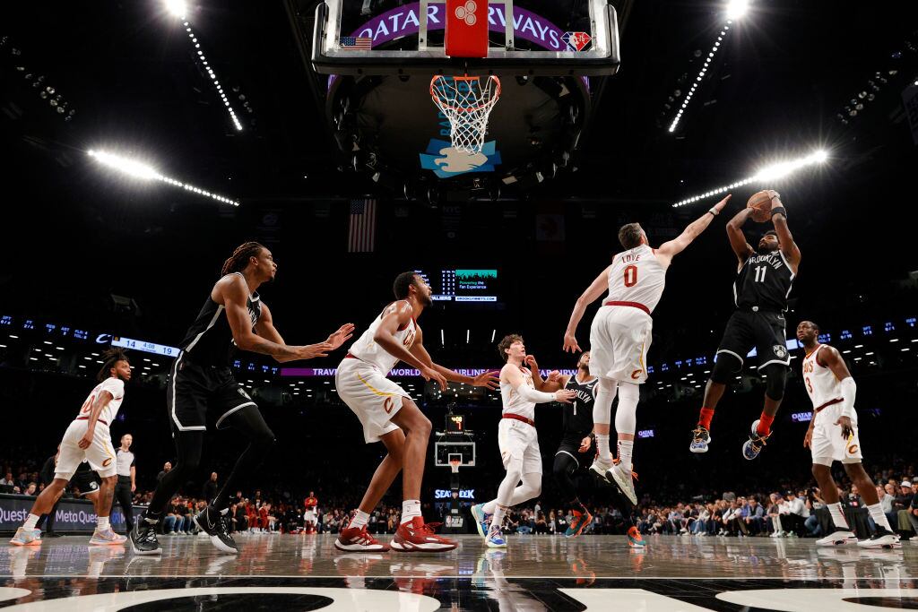NEW YORK, NEW YORK - APRIL 12: Kyrie Irving #11 of the Brooklyn Nets goes to the basket as Kevin Love #0 of the Cleveland Cavaliers defends during the Eastern Conference 2022 Play-In Tournament at Barclays Center on April 12, 2022 in the Brooklyn borough of New York City. The Nets won 115-108. NOTE TO USER: User expressly acknowledges and agrees that, by downloading and or using this photograph, User is consenting to the terms and conditions of the Getty Images License Agreement. (Photo by Sarah Stier/Getty Images)