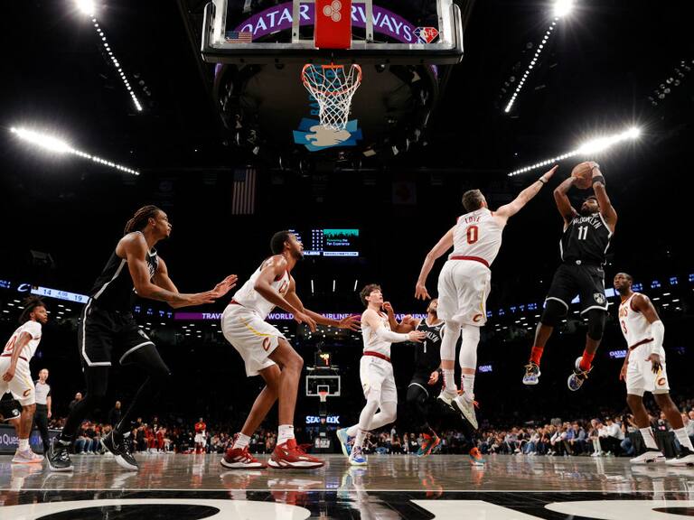 NEW YORK, NEW YORK - APRIL 12: Kyrie Irving #11 of the Brooklyn Nets goes to the basket as Kevin Love #0 of the Cleveland Cavaliers defends during the Eastern Conference 2022 Play-In Tournament at Barclays Center on April 12, 2022 in the Brooklyn borough of New York City. The Nets won 115-108. NOTE TO USER: User expressly acknowledges and agrees that, by downloading and or using this photograph, User is consenting to the terms and conditions of the Getty Images License Agreement. (Photo by Sarah Stier/Getty Images)