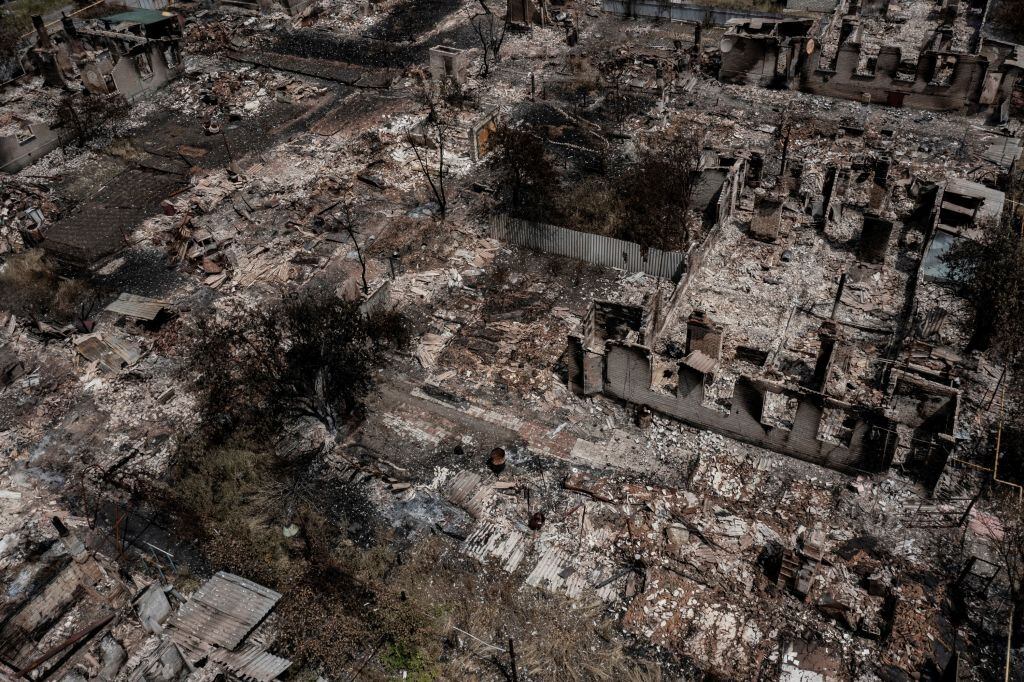 An aerial view shows destroyed houses after strike in the town of Pryvillya at the eastern Ukrainian region of Donbas on June 14, 2022, amid Russian invasion of Ukraine. - The cities of Severodonetsk and Lysychansk, which are separated by a river, have been targeted for weeks as the last areas still under Ukrainian control in the eastern Lugansk region. (Photo by ARIS MESSINIS / AFP) (Photo by ARIS MESSINIS/AFP via Getty Images)