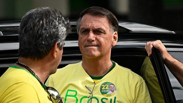Brazilian President and re-election candidate Jair Bolsonaro arrives to vote at a polling station in Rio de Janeiro, Brazil, on October 30, 2022, during the presidential run-off election. - After a bitterly divisive campaign and inconclusive first-round vote, Brazil elects its next president in a cliffhanger runoff between far-right incumbent Jair Bolsonaro and veteran leftist Luiz Inacio Lula da Silva. (Photo by MAURO PIMENTEL / AFP) (Photo by MAURO PIMENTEL/AFP via Getty Images)