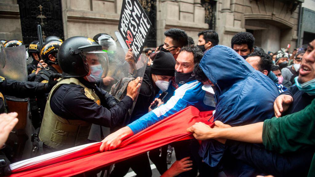 Supporters of ousted Peruvian President Martin Vizcarra, who was removed in an impeachment vote late Monday, struggle with riot police as they demonstrate against the new government in Lima on November 10, 2020. - Speaker of Congress Manuel Merino assumed office Tuesday as Peru's third president in four years, amid street protests and market jitters after the impeachment of Martin Vizcarra over corruption allegations. (Photo by Ernesto BENAVIDES / AFP) (Photo by ERNESTO BENAVIDES/AFP via Getty Images)
