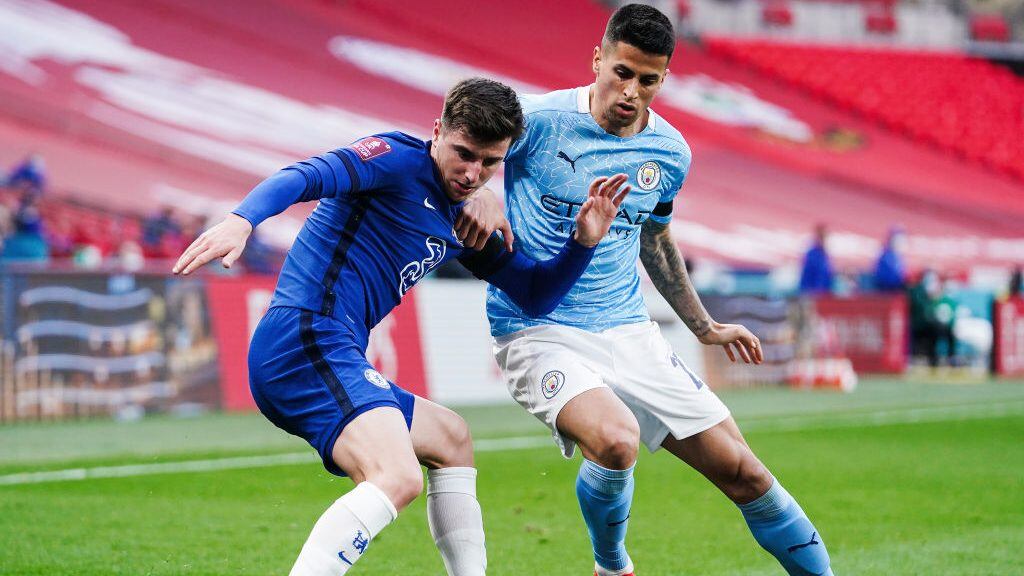 LONDON, ENGLAND - APRIL 17: Mason Mount of Chelsea challenges Joao Cancelo of Manchester City during the Semi Final of the Emirates FA Cup match between Manchester City and Chelsea FC at Wembley Stadium on April 17, 2021 in London, England. Sporting stadiums around the UK remain under strict restrictions due to the Coronavirus Pandemic as Government social distancing laws prohibit fans inside venues resulting in games being played behind closed doors. (Photo by Matt McNulty - Manchester City/Manchester City FC via Getty Images)