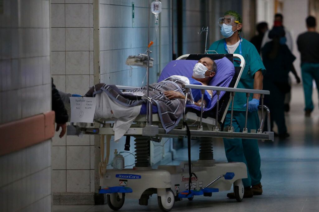 SANTIAGO, CHILE - JUNE 16: Health worker carry a COVID-19 patient during the coronavirus pandemic at San Jose Hospital on June 16, 2020 in Santiago, Chile. On Monday, President Piñera extended the State of Catastrophe for 90 days to better control the outbreak of COVID-19 in the country. (Photo by Marcelo Hernandez/Getty Images)