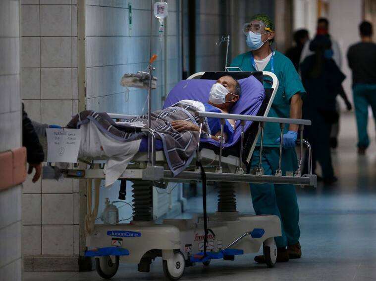 SANTIAGO, CHILE - JUNE 16: Health worker carry a COVID-19 patient during the coronavirus pandemic at San Jose Hospital on June 16, 2020 in Santiago, Chile. On Monday, President Piñera extended the State of Catastrophe for 90 days to better control the outbreak of COVID-19 in the country. (Photo by Marcelo Hernandez/Getty Images)
