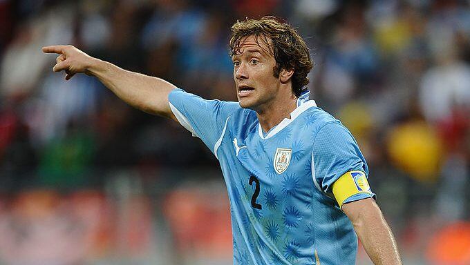 PORT ELIZABETH, SOUTH AFRICA - JUNE 26:  Captain Diego Lugano of Uruguay directs his team mates during the 2010 FIFA World Cup South Africa Round of Sixteen match between Uruguay and South Korea at Nelson Mandela Bay Stadium on June 26, 2010 in Nelson Mandela Bay/Port Elizabeth, South Africa.  (Photo by Laurence Griffiths/Getty Images)
