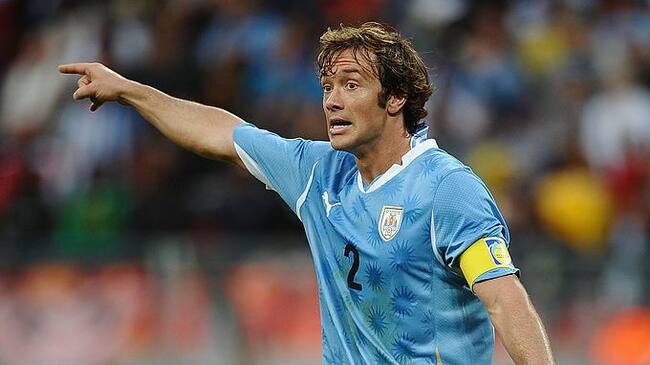PORT ELIZABETH, SOUTH AFRICA - JUNE 26: Captain Diego Lugano of Uruguay directs his team mates during the 2010 FIFA World Cup South Africa Round of Sixteen match between Uruguay and South Korea at Nelson Mandela Bay Stadium on June 26, 2010 in Nelson Mandela Bay/Port Elizabeth, South Africa. (Photo by Laurence Griffiths/Getty Images)
