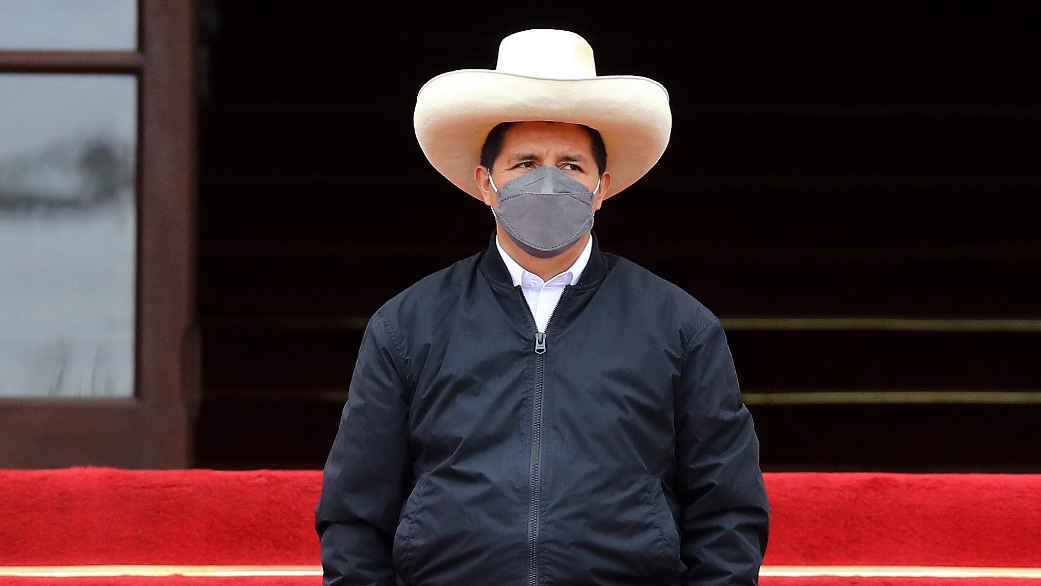 LIMA, PERU - DECEMBER 05: Peruvian President Pedro Castillo (C) looks on during an event to deliver firetrucks to Volunteer firefighters of Peru on December 5, 2021 in Lima, Peru. After only four months in power, National Congress will vote this week on whether to start the formal impeachment process to Castillo. The Left-wing President will also be questioned by prosecutors on December 14th over promotions for military officers. (Photo by Leonardo Fernandez/Getty Images)