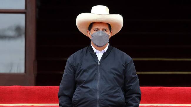 LIMA, PERU - DECEMBER 05: Peruvian President Pedro Castillo (C) looks on during an event to deliver firetrucks to Volunteer firefighters of Peru on December 5, 2021 in Lima, Peru. After only four months in power, National Congress will vote this week on whether to start the formal impeachment process to Castillo. The Left-wing President will also be questioned by prosecutors on December 14th over promotions for military officers. (Photo by Leonardo Fernandez/Getty Images)