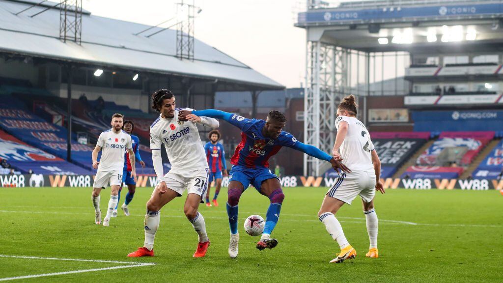 LONDON, ENGLAND - NOVEMBER 07: Wilfried Zaha of Palace is surrounded by Pascal Struijk and Luke Ayling of Leeds during the Premier League match between Crystal Palace and Leeds United at Selhurst Park on November 7, 2020 in London, United Kingdom. Sporting stadiums around the UK remain under strict restrictions due to the Coronavirus Pandemic as Government social distancing laws prohibit fans inside venues resulting in games being played behind closed doors. (Photo by Charlotte Wilson/Offside/Offside via Getty Images)