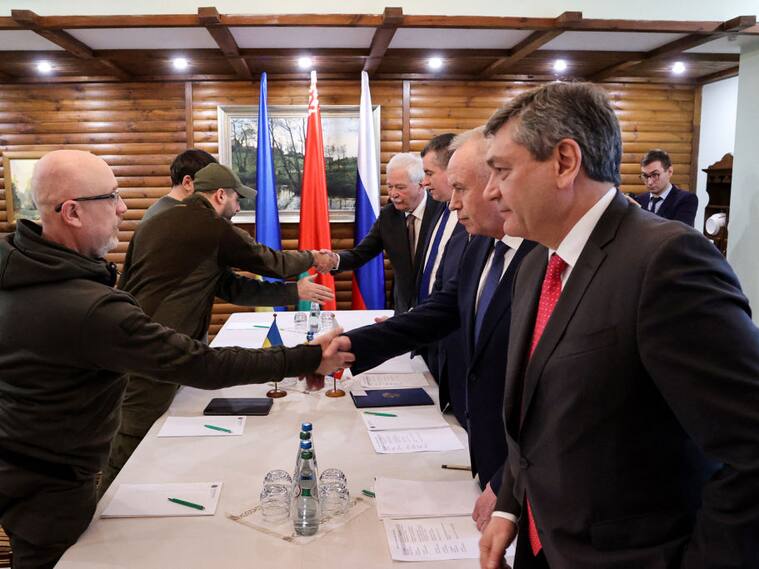 TOPSHOT - Ukrainian Defence minister Oleksii Reznikov (L) shakes hands with Russian negotiators prior the talks between delegations from Ukraine and Russia in Belarus' Brest region on March 3, 2022, following the Russian invasion of Ukraine. - Russia and Ukraine will discuss a ceasefire at upcoming talks on the border between Poland and Belarus, Moscow's chief negotiator said on March 2, nearly one week into Russia's invasion of its pro-Western neighbour. - Belarus OUT (Photo by Maxim GUCHEK / BELTA / AFP) / Belarus OUT (Photo by MAXIM GUCHEK/BELTA/AFP via Getty Images)