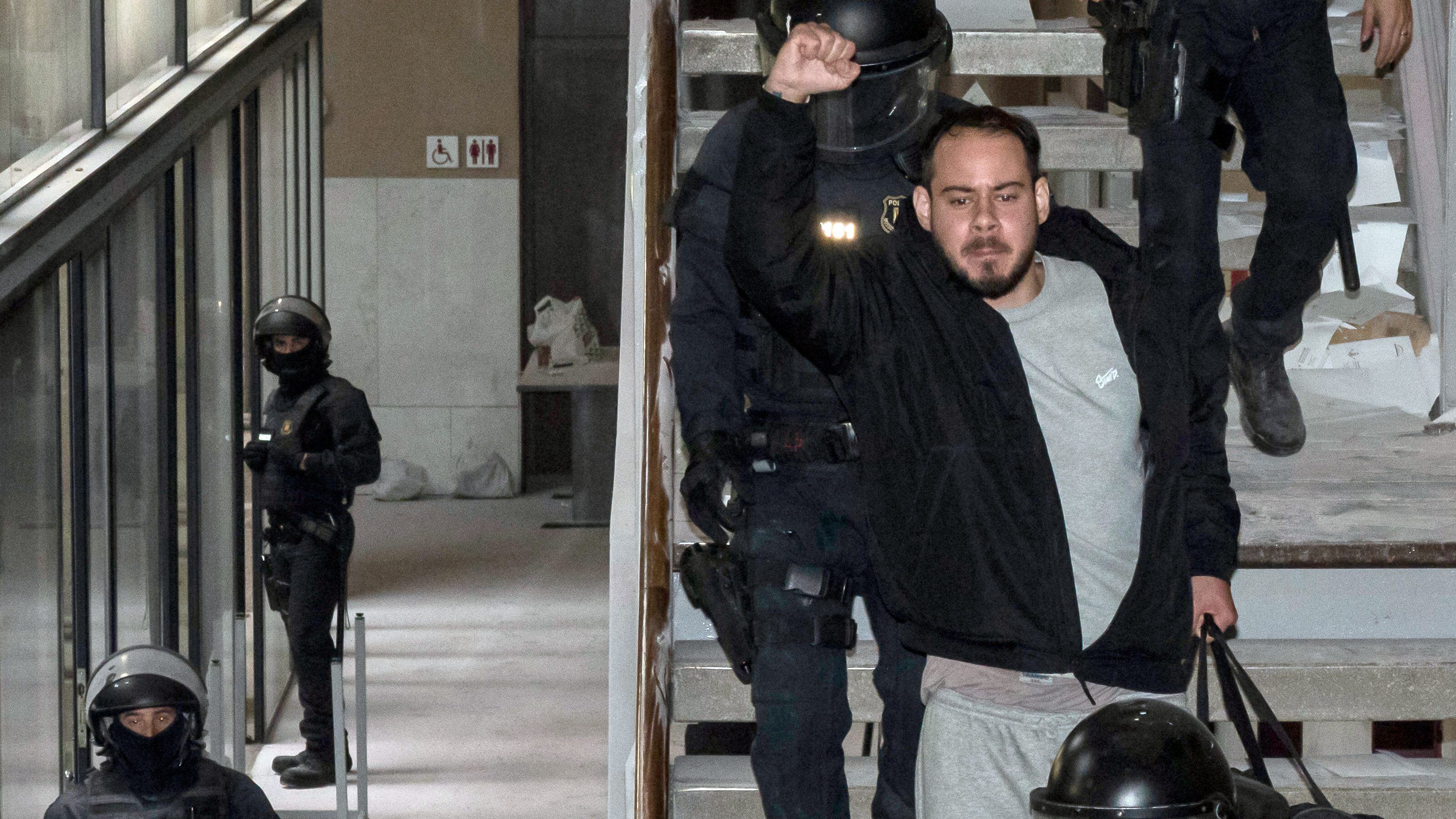 Catalan rapper Pablo Hasel is arrested by police at the University of Lleida, 150 kms (90 miles) west of Barcelona, on February 16, 2021 where he had barricaded himself. - Spanish police today arrested a rapper who barricaded himself inside a university after he was controversially sentenced to nine months in jail over a string of tweets, television images showed. Pablo Hasel had been given until the night of February 12 to turn himself in to begin serving his sentence after being convicted for glorifying terrorism, slander and libel against the crown and state institutions. (Photo by J. Martin / AFP) (Photo by J. MARTIN/AFP via Getty Images)