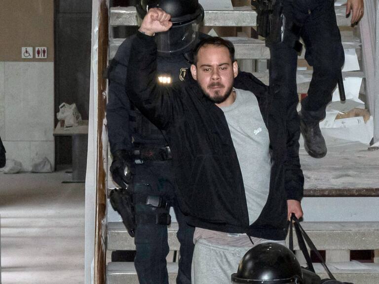 Catalan rapper Pablo Hasel is arrested by police at the University of Lleida, 150 kms (90 miles) west of Barcelona, on February 16, 2021 where he had barricaded himself. - Spanish police today arrested a rapper who barricaded himself inside a university after he was controversially sentenced to nine months in jail over a string of tweets, television images showed. Pablo Hasel had been given until the night of February 12 to turn himself in to begin serving his sentence after being convicted for glorifying terrorism, slander and libel against the crown and state institutions. (Photo by J. Martin / AFP) (Photo by J. MARTIN/AFP via Getty Images)