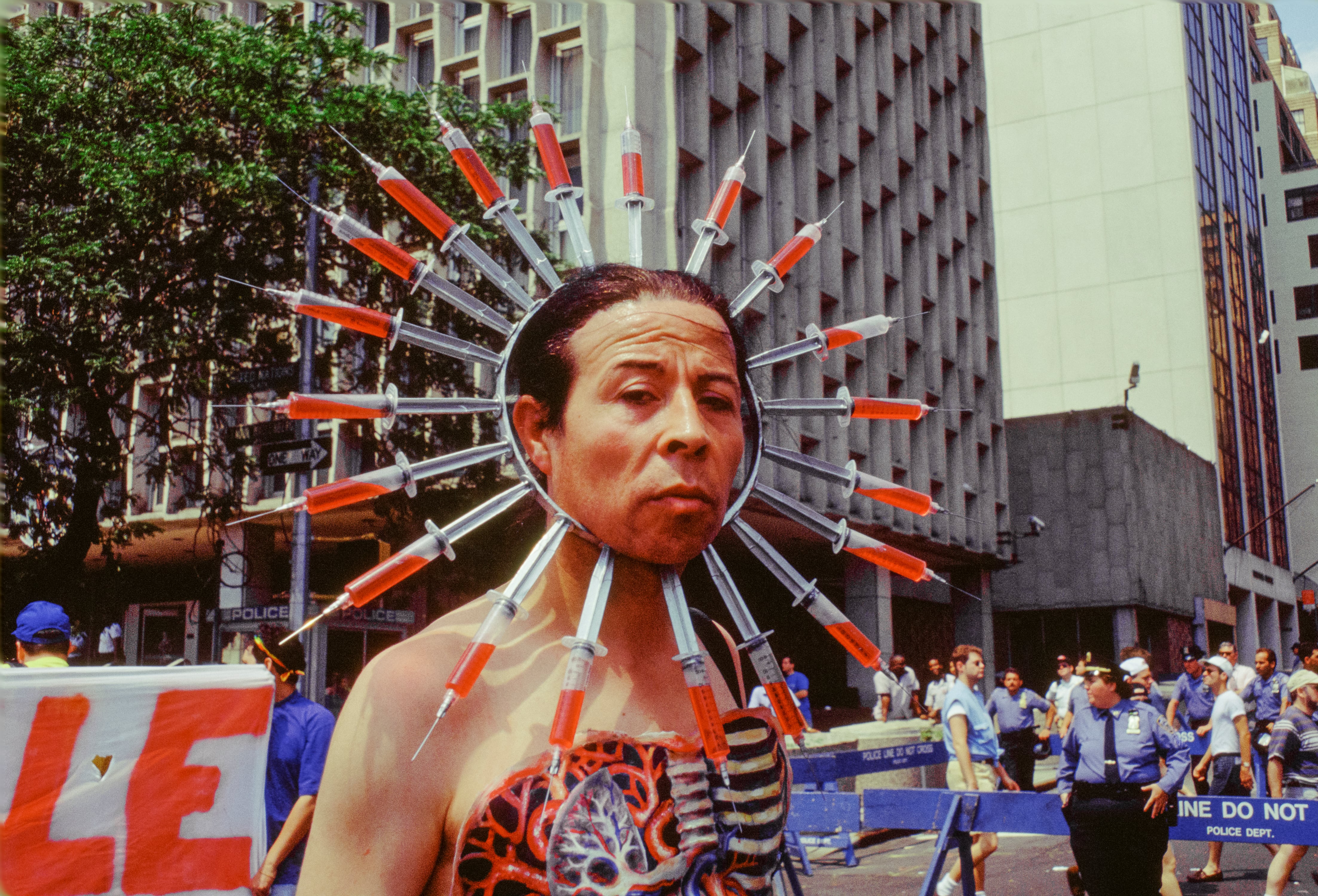 Chilean author and AIDS activist Pedro Lemebel (1952 - 2015), wearing body paint and a headdress of syringes, during the annual Gay Pride Parade, New York, New York, June 26, 1994. (Photo by Barbara Alper/Getty Images)