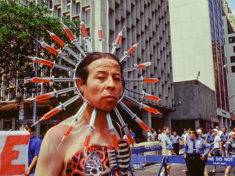 Chilean author and AIDS activist Pedro Lemebel (1952 - 2015), wearing body paint and a headdress of syringes, during the annual Gay Pride Parade, New York, New York, June 26, 1994. (Photo by Barbara Alper/Getty Images)
