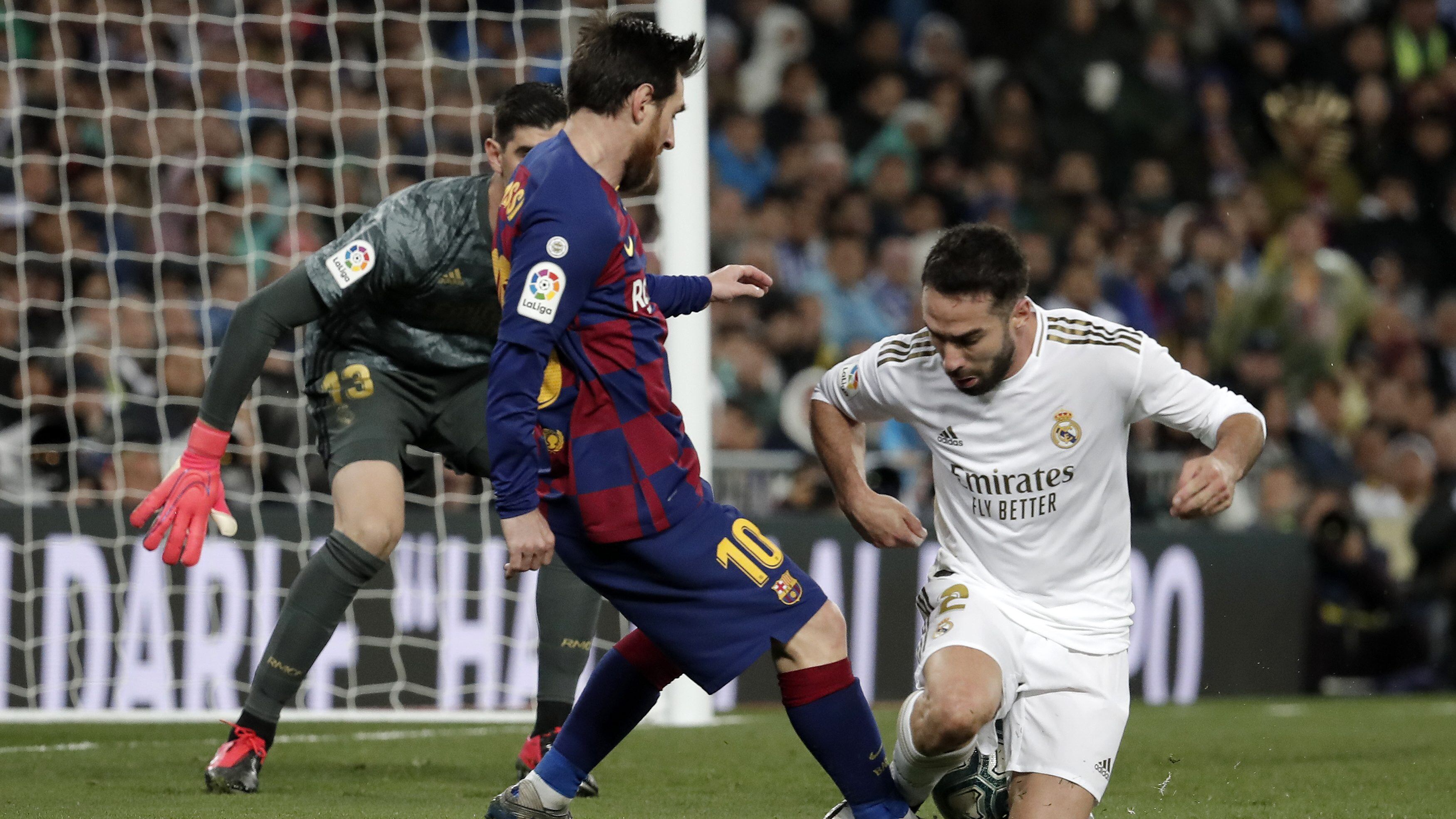 MADRID, SPAIN - MARCH 1: Dani Carvajal of Real Madrid in action against Lionel Messi of Barcelona during the Spanish League football match between Real Madrid and Barcelona at the Santiago Bernabeu stadium in Madrid on March 1, 2020. (Photo by Burak Akbulut/Anadolu Agency via Getty Images)