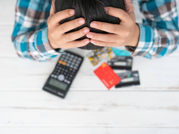 Concept of The man is stressed with debt owed by using credit card