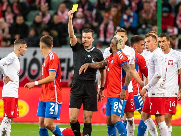 WARSAW, POLAND - NOVEMBER 16: referee Harm Osmers show Eugenio Mena of Chile the yellow card during the friendly match between Poland v Chile on November 16, 2022 in Warsaw, Poland. (Photo by Mateusz Slodkowski/DeFodi Images via Getty Images)