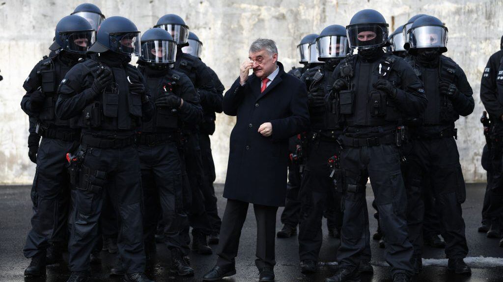 04 February 2019, North Rhine-Westphalia, Bochum: NRW Minister of the Interior Herbert Reul (CDU) stands between the emergency forces of a new Evidence Preservation and Arrest Unit (BFE) as part of an exercise by the North Rhine-Westphalian police. The specially trained unit is to secure evidence during demonstrations, raids or riots on the fringes of football matches and arrest violent disturbers and criminals. Photo: Ina Fassbender/dpa (Photo by Ina Fassbender/picture alliance via Getty Images)