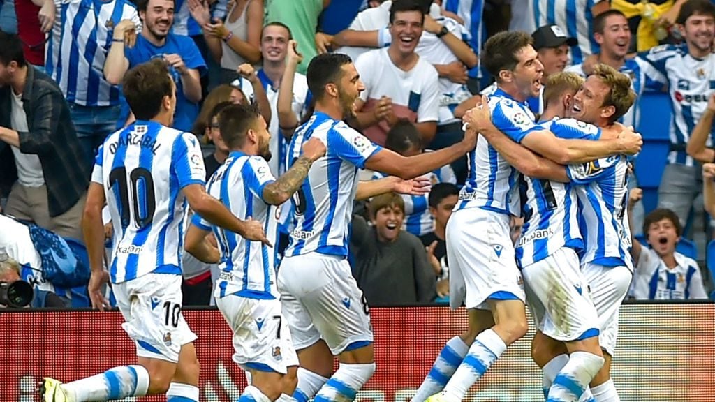 Real Sociedad's players celebrate after Real Sociedad's Spanish defender Nacho Monreal scored a goal during the Spanish league football match Real Sociedad against Club Atletico de Madrid at The Anoeta Stadium in San Sebastian on September 14, 2019. (Photo by ANDER GILLENEA / AFP)        (Photo credit should read ANDER GILLENEA/AFP via Getty Images)
