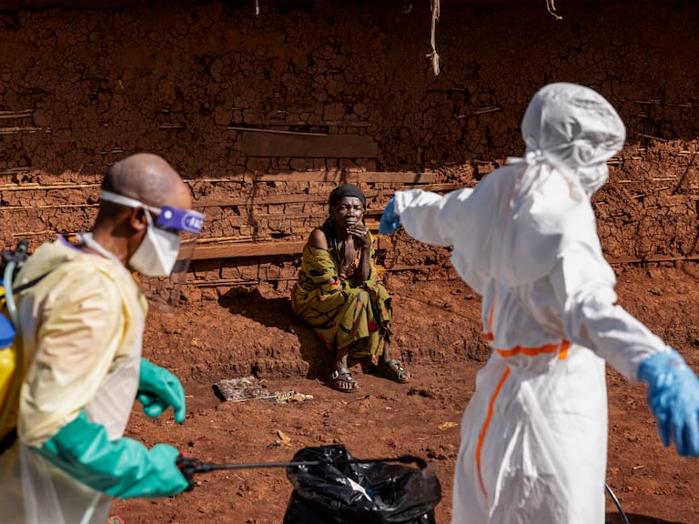 MONGBWALU, DEMOCRATIC REPUBLIC OF CONGO - MAY 24: The mother of the late Saidi Mumbere watches as health workers carry out Ebola response activities in the community of Mongbwaluon May 24, 2026 in Mongbwalu, Ituri Province, Democratic Republic of Congo. The World Health Organization (WHO) has declared the Ebola outbreak in the Democratic Republic of Congo (DRC) and Uganda a "public health emergency of international concern," as the death toll and number of confirmed cases continue to rise. The current epidemic is caused by the Bundibugyo virus, one of several Orthoebolaviruses that can cause Ebola disease, and for which there are no approved vaccines. The highest number of cases have been reported in Congo's eastern Ituri province, bordering Uganda. Global health officials have expressed grave concern over the capacity to contain the outbreak in a region already facing a humanitarian crisis, with highly mobile populations displaced by conflict and economic factors. (Photo by Michel Lunanga/Getty Images)