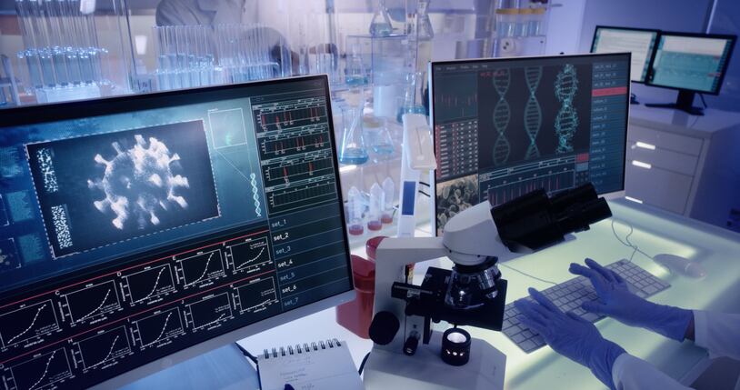 Modern laboratory interior. Coronavirus research. Pathogen model on the screens