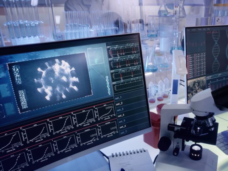 Modern laboratory interior. Coronavirus research. Pathogen model on the screens