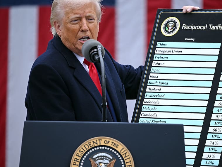 US President Donald Trump holds a chart as he delivers remarks on reciprocal tariffs during an event in the Rose Garden entitled "Make America Wealthy Again" at the White House in Washington, DC, on April 2, 2025. Trump geared up to unveil sweeping new "Liberation Day" tariffs in a move that threatens to ignite a devastating global trade war. Key US trading partners including the European Union and Britain said they were preparing their responses to Trump's escalation, as nervous markets fell in Europe and America. (Photo by Brendan SMIALOWSKI / AFP) (Photo by BRENDAN SMIALOWSKI/AFP via Getty Images)
