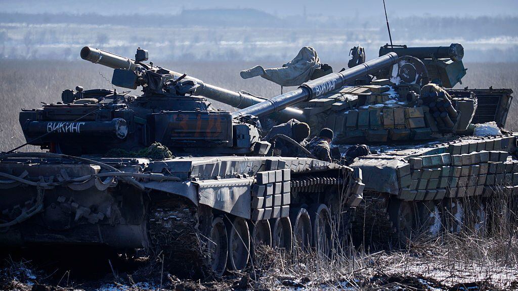 VUGLEGIRSK , UKRAINE - FEBRUARY 18: Pro-Russian rebels tow a seized Ukrainian tank (R) on February 18, 2015, near Vuglegirsk, Ukraine. Ukrainian troops have been forced to retreat from Debaltseve following continued fighting as rebels advance on the town in spite of the recent ceasefire agreement. (Photo by Pierre Crom/Getty Images)