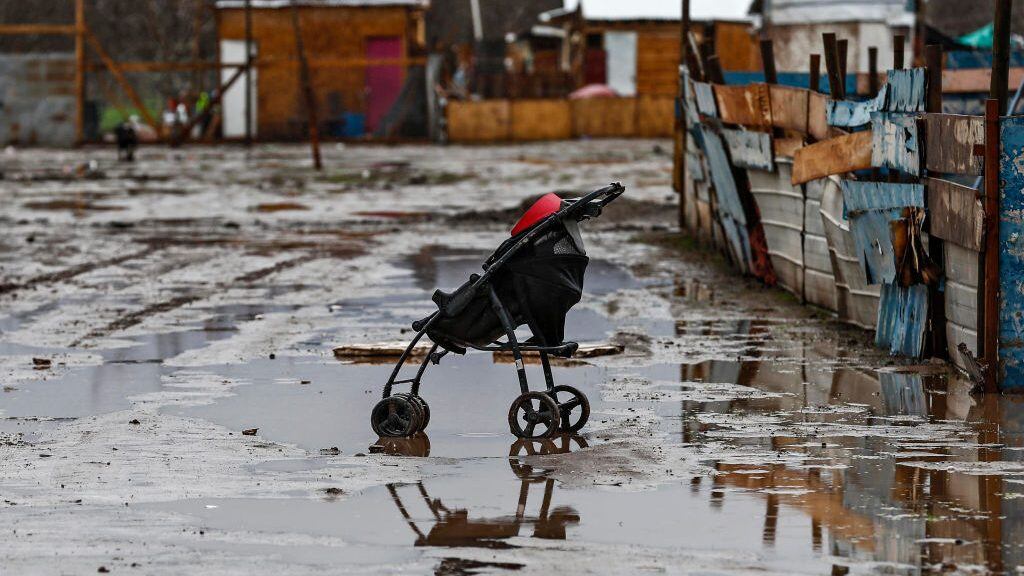TOPSHOT - A pram is seen in a waterlogged street in a poor sector of Santiago on June 29, 2020 after heavy rains fell in central and southern Chile. - Intense rainfall fell since early Monday morning in central and southern Chile, causing flooding and river overflows in at least eight regions of the country, the National Emergency Office (Onemi) reported. (Photo by Javier TORRES / AFP) (Photo by JAVIER TORRES/AFP via Getty Images)