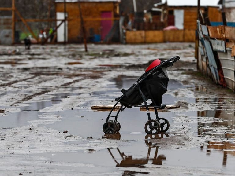TOPSHOT - A pram is seen in a waterlogged street in a poor sector of Santiago on June 29, 2020 after heavy rains fell in central and southern Chile. - Intense rainfall fell since early Monday morning in central and southern Chile, causing flooding and river overflows in at least eight regions of the country, the National Emergency Office (Onemi) reported. (Photo by Javier TORRES / AFP) (Photo by JAVIER TORRES/AFP via Getty Images)