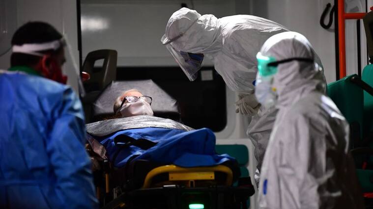 An elderly man with symptoms of the new coronavirus is carried into an ambulance to be transferred from the Carpe Diem nursing home to a hospital in Buenos Aires on May 7, 2020. (Photo by RONALDO SCHEMIDT / AFP) (Photo by RONALDO SCHEMIDT/AFP via Getty Images)