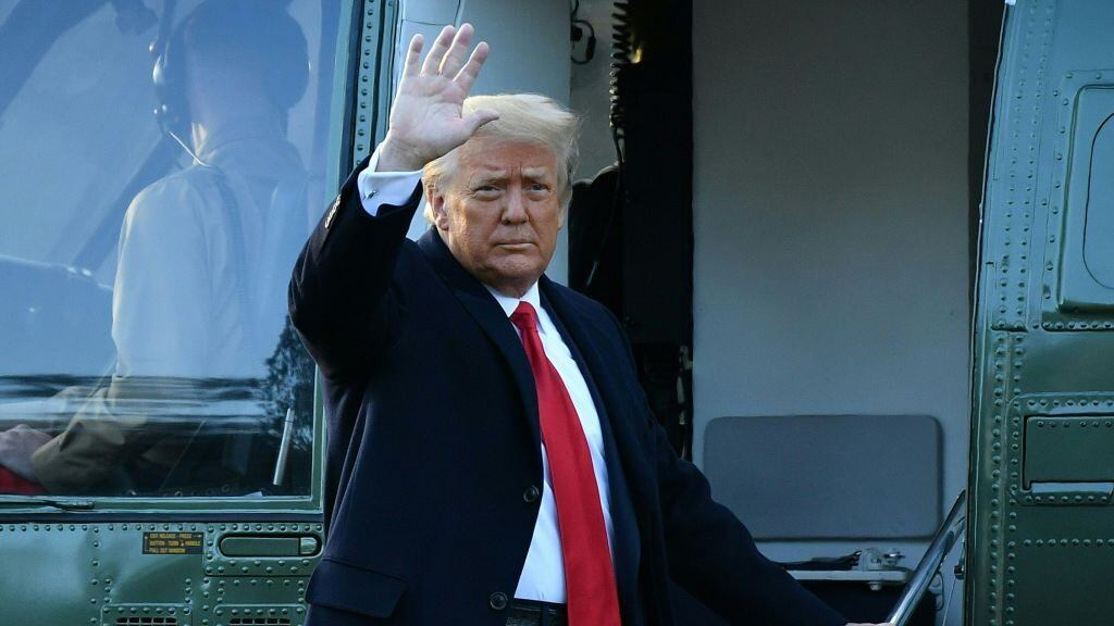 TOPSHOT - Outgoing US President Donald Trump waves as he boards Marine One at the White House in Washington, DC, on January 20, 2021. - President Trump travels his Mar-a-Lago golf club residence in Palm Beach, Florida, and will not attend the inauguration for President-elect Joe Biden. (Photo by MANDEL NGAN / AFP) (Photo by MANDEL NGAN/AFP via Getty Images)