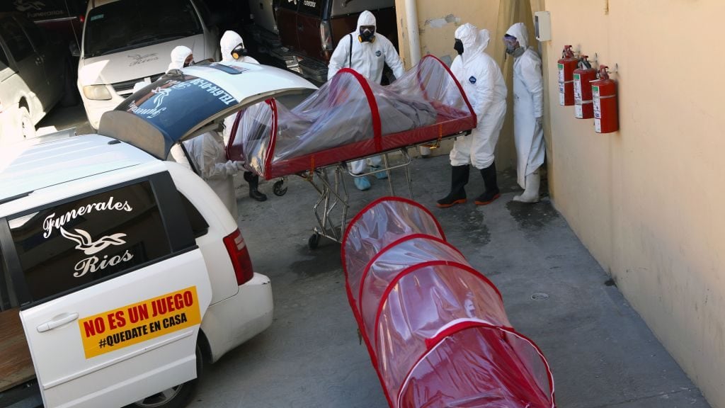 TOPSHOT - Workers of a funeral service show the process they carry out when working with victims of infectious diseases, in the face of the coronavirus COVID-19 pandemic, in Ciudad Juarez, Chihuahua State, Mexico, on April 7, 2020. - The coronavirus pandemic has killed more than 75,000 people worldwide since it emerged in China in December, according to a tally compiled by AFP from official sources at 0945 GMT on Tuesday. (Photo by Herika MARTINEZ / AFP) (Photo by HERIKA MARTINEZ/AFP via Getty Images)