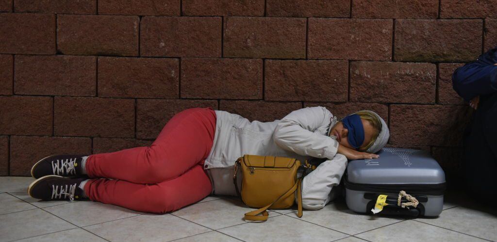 HANGA ROA, CHILE - 2019/09/23: A woman is seen sleeping at the airportHanga Roa is the capital of Easter Island, a Chilean island in the southeastern Pacific Ocean. The village has around 5,000 inhabitants, which comprises between 87 and 90 percent of the total population of the island. Excluding a small percentage still engaged in traditional fishing and small-scale farming, the majority of the population is engaged in tourism which is the main source of income. (Photo by John Milner/SOPA Images/LightRocket via Getty Images)