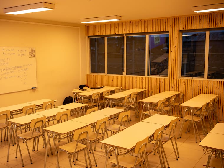 Clean, Brightly Lit Education Room with Desks and Wooden Paneling