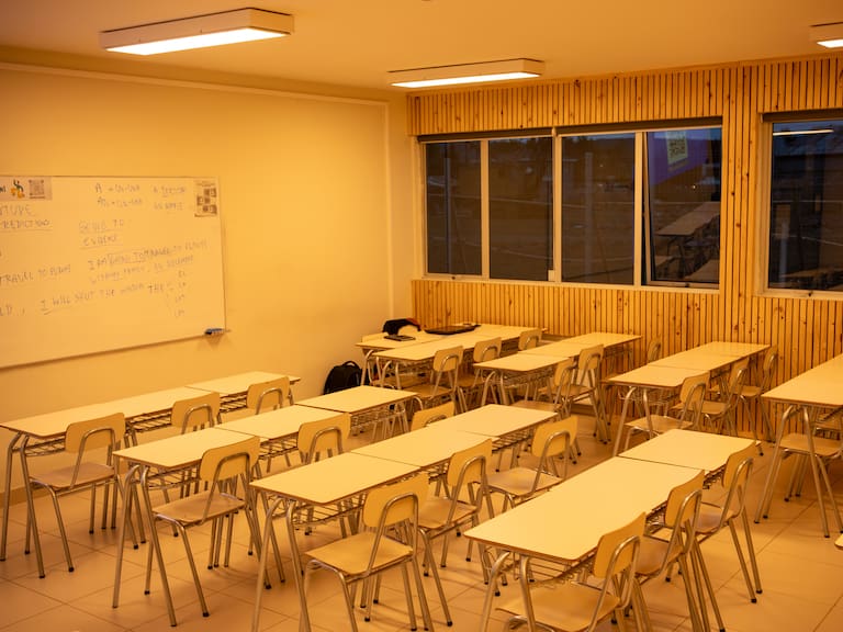 Clean, Brightly Lit Education Room with Desks and Wooden Paneling