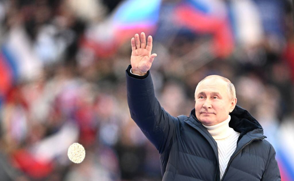 MOSCOW, RUSSIA - MARCH 18: (----EDITORIAL USE ONLY â MANDATORY CREDIT - "KREMLIN PRESS OFFICE / HANDOUT" - NO MARKETING NO ADVERTISING CAMPAIGNS - DISTRIBUTED AS A SERVICE TO CLIENTS----) Russian President Vladimir Putin greets the crowd at a concert marking the eighth anniversary of Russia's annexation of Crimea at the Luzhniki stadium in Moscow, Russia on March 18, 2022. (Photo by Kremlin Press Office / Handout/Anadolu Agency via Getty Images)
