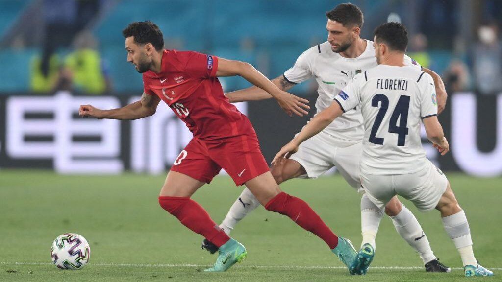 Turkey's midfielder Hakan Calhanoglu, Italy's forward Domenico Berardi and Italy's defender Alessandro Florenzi vie for the ball during the UEFA EURO 2020 Group A football match between Turkey and Italy at the Olympic Stadium in Rome on June 11, 2021. (Photo by Mike Hewitt / POOL / AFP) (Photo by MIKE HEWITT/POOL/AFP via Getty Images)