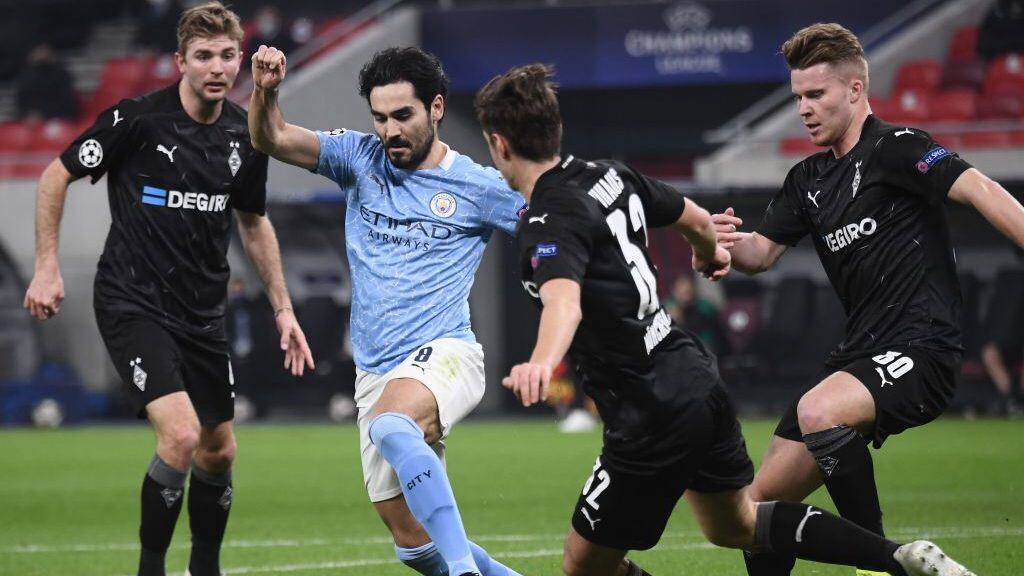 Manchester City's German midfielder Ilkay Gundogan (2L) and Moenchengladbach's German midfielder Florian Neuhaus vie for the ball during the UEFA Champions League, last 16, 1st-leg football match Borussia Moenchengladbach v Manchester City at the Puskas Arena in Budapest on February 24, 2021. (Photo by Attila KISBENEDEK / AFP) (Photo by ATTILA KISBENEDEK/AFP via Getty Images)