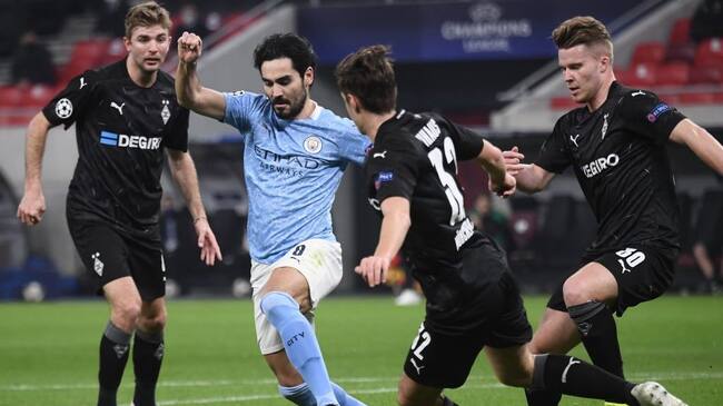 Manchester City's German midfielder Ilkay Gundogan (2L) and Moenchengladbach's German midfielder Florian Neuhaus vie for the ball during the UEFA Champions League, last 16, 1st-leg football match Borussia Moenchengladbach v Manchester City at the Puskas Arena in Budapest on February 24, 2021. (Photo by Attila KISBENEDEK / AFP) (Photo by ATTILA KISBENEDEK/AFP via Getty Images)