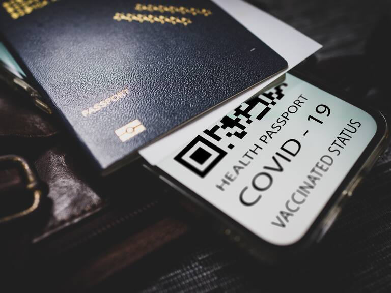 Covid-19 passport with QR code on smartphone, Getty Images.