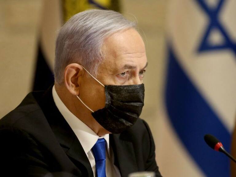 Israeli Prime Minister Benjamin Netanyahu, wearing a mask for protection against the COVID-19 pandemic, attends a special cabinet meeting on the occasion of &quot;Jerusalem Day&quot; at the city&#039;s municipality building on May 9, 2021. - Clashes have repeatedly broken out over the past week in east Jerusalem&#039;s Sheikh Jarrah neighbourhood, fuelled by a years-long attempt by Jewish settlers to take over Palestinian homes. Israel&#039;s Supreme Court is to hold a new hearing in the case on Monday, when Israelis mark Jerusalem Day to celebrate the &quot;liberation&quot; of the city. (Photo by Amit SHABI / POOL / AFP) (Photo by AMIT SHABI/POOL/AFP via Getty Images)